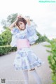 A woman in a blue and pink kimono posing for a picture.