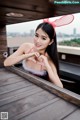 A woman in a bunny costume making a heart with her hands.