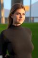 A woman in a black shirt standing in a field.