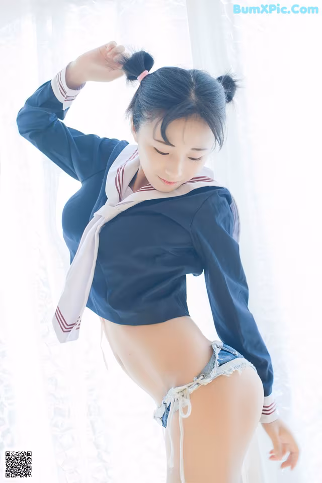 A woman in a school uniform posing for a picture.