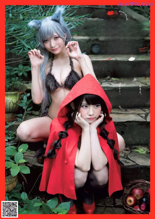 A woman in a red hooded cloak is posing next to another woman.